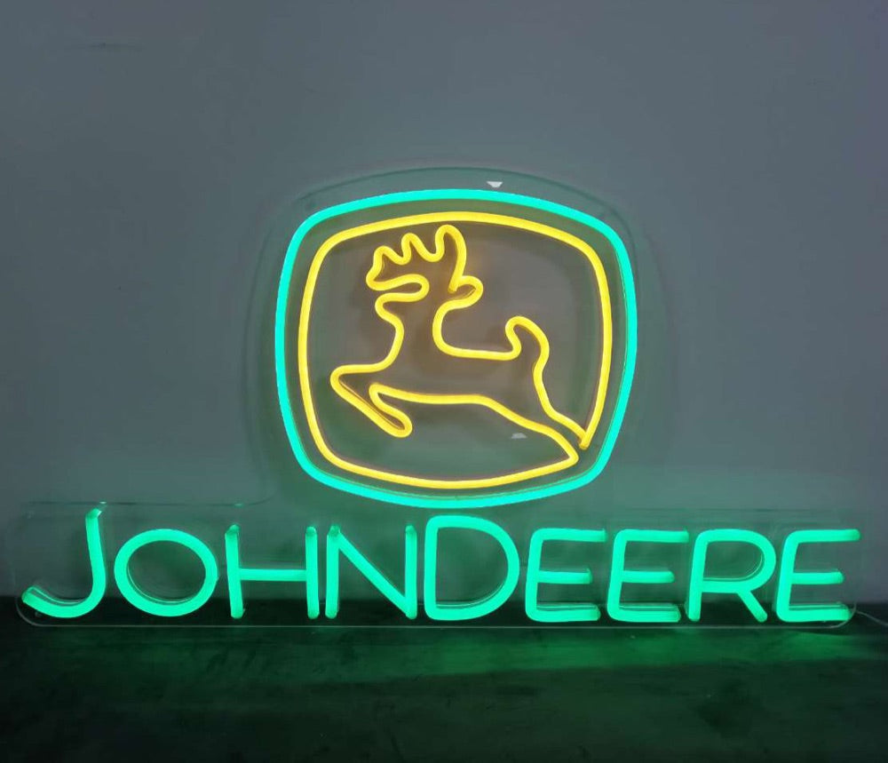 Finished John Deere logo neon sign glowing in green and yellow